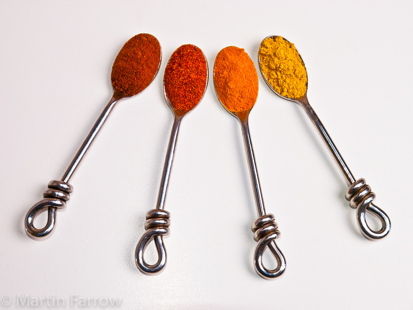 Spice-Fan 
 Fan of spoons with coloured spice 
 Keywords: flavouring, seasoning, spices, still life, studio,spoon,orange,yellow,row