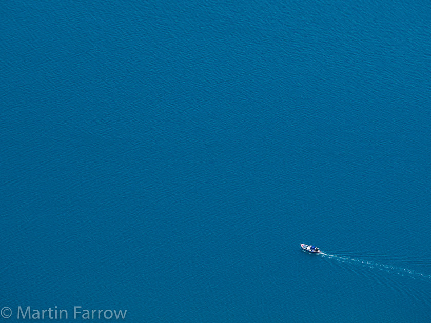 Solitude 
 Small boat on big sea 
 Keywords: Greece, Samos, abstract, clear, blue,small,boat,lone,lonely,alone,ripples,calm,solitude,one