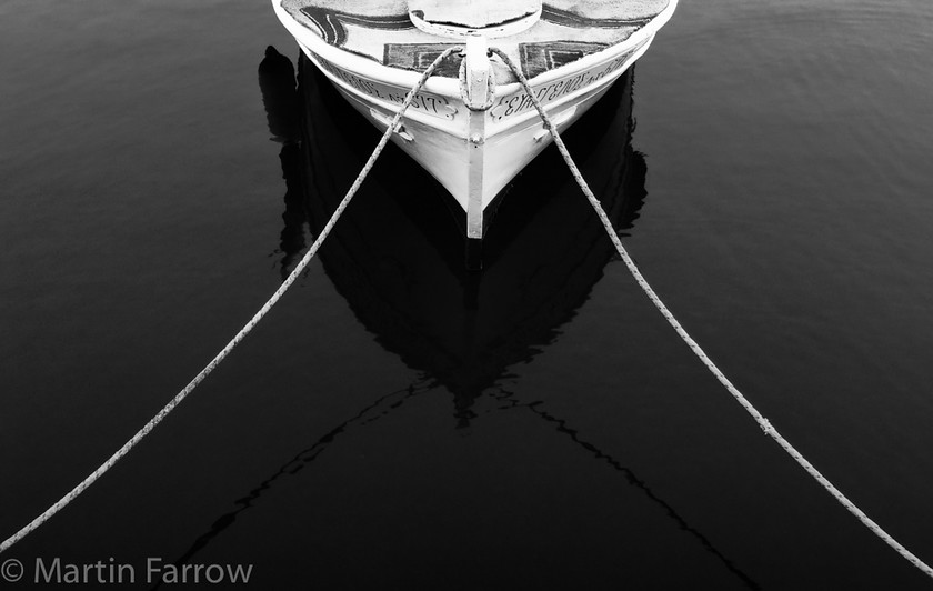 Triangles 
 Bow of boat with mooring lines 
 Keywords: Crete, Greece, boats, mono,boat,rope,bow,shore,harbour,moored,mooring,triangle,sea,harbour