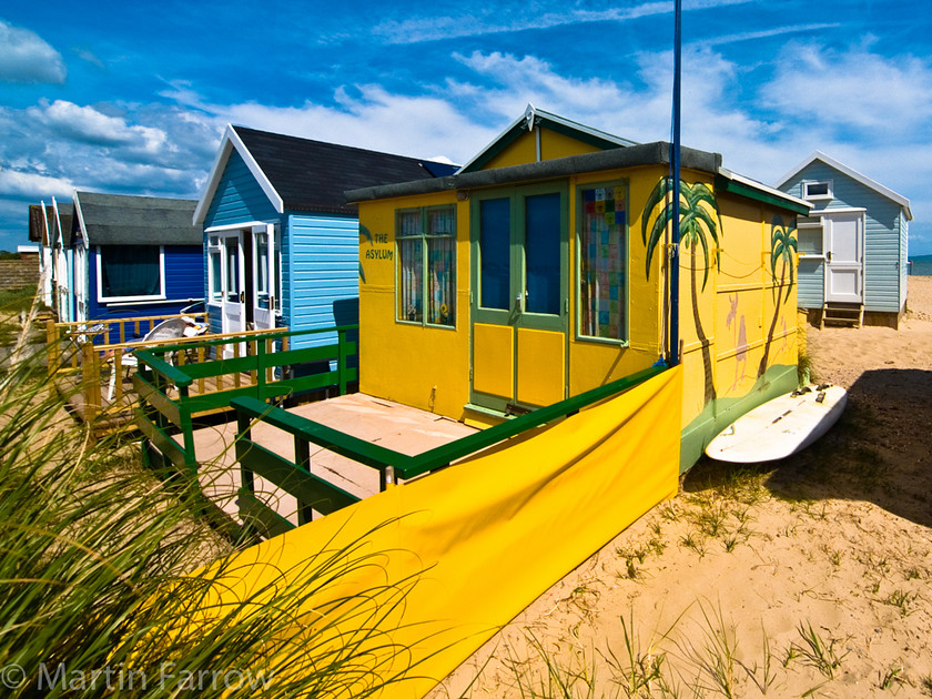 Asylum 
 Brightly painted beach hut 
 Keywords: beach,hut,bright,yellow,shore,sand,grass