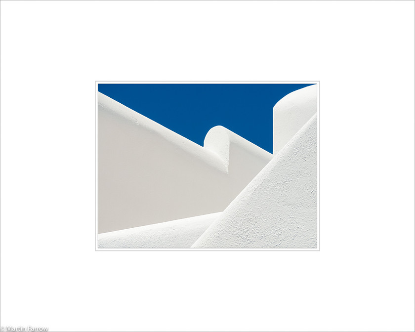 01 White-Walls 
 Many angled white walls against blue sky 
 Keywords: ARPS panel fine art blue white simple abstract graphic architecture angle diagonal wall sky Santorini Greece island