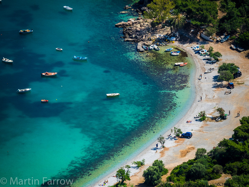 Quiet-Beach 
 Quiet beach with moored boats 
 Keywords: Greece, Samos, beach, aerial,shore,water,clear,boats,moored,tranquil,warm,secluded