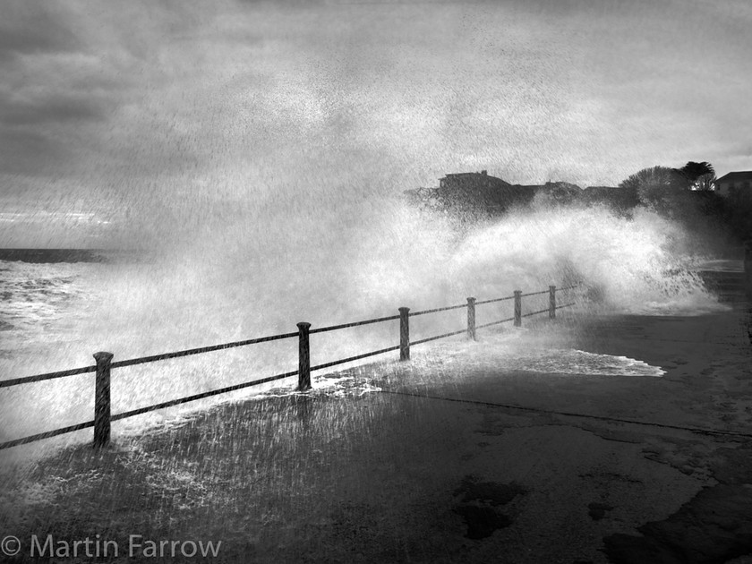 Crashing-Wave 
 Large wave crashing over promenade 
 Keywords: beach, breaking, clouds, foam, shore, sky, spray, waves,sea,ocean,spray,wet,coast