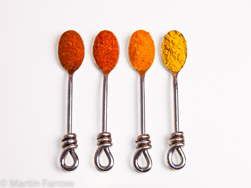 Spice-Row 
 Row of spoons with coloured spices 
 Keywords: flavouring, seasoning, spices, still life, studio,spoon,orange,yellow,row