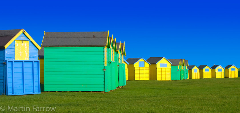 Bognor-Beach-Huts 
 Yellow, green and blue beach huts 
 Keywords: Beach huts, Bognor Regis, beach, sea, water,blue,yellow,green,bright,bold,colour,grass,row