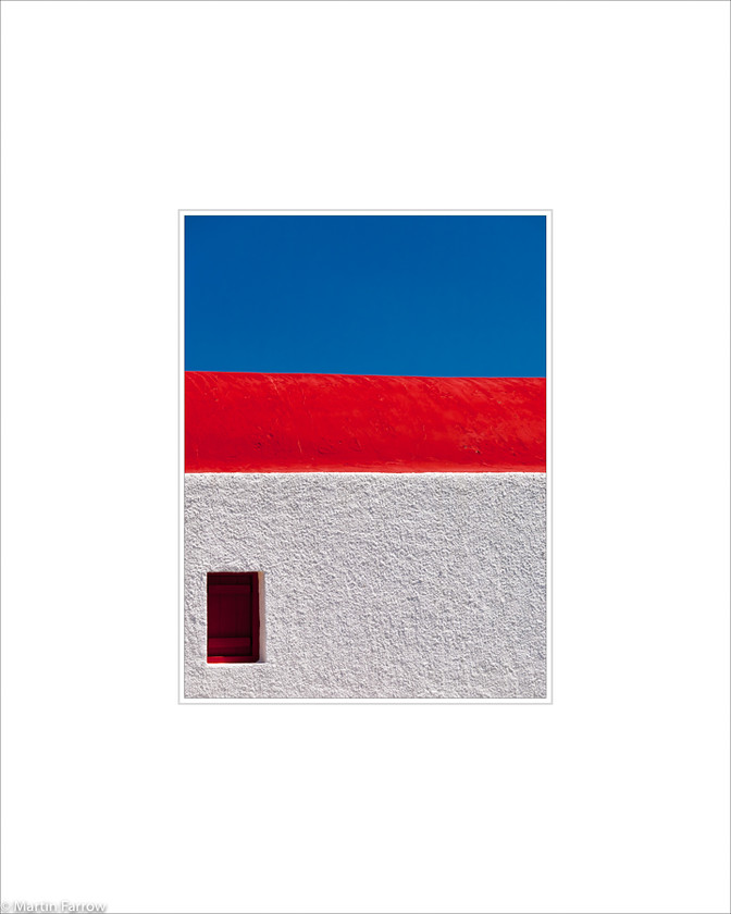 12 Tri-Colour 
 White wall with red roof against blue sky 
 Keywords: ARPS panel fine art blue white simple abstract graphic architecture red church wall roof sky lines horizontal Mykonos island Greece